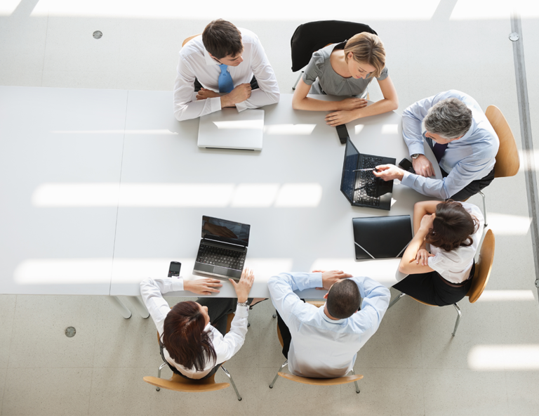 work-group-comparing-regulations-around-a-conference-table