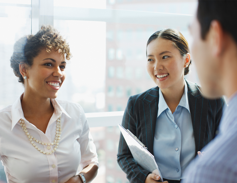 two-women-smiling-one-holding-document